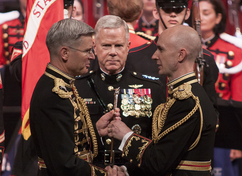 General James F. Amos observes the transfer of the baton from Michael J. Colburn to Jason Fettig in 2014