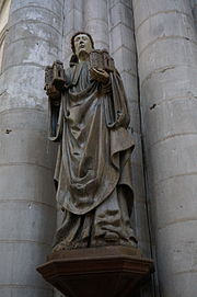 Photographie en couleurs d'une statue nichée au creux d'un pilier d'église.