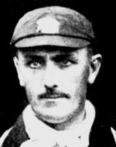 A close up of a man in an MCC cap