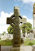 Muiredach's High Cross (9th century) clearly depicting the Irish léine and mantles. Shoes or brogues and pants were also commonplace in Ireland since the early Medieval period long before the Anglo-Normans came to Ireland.