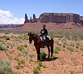 Image 34A Navajo boy in the desert in present-day Monument Valley in Arizona with the "Three Sisters" rock formation in the background in 2007 (from Indigenous peoples of the Americas)