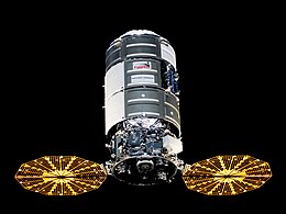 Silver cylindrical spacecraft with gold solar panels amid the blackness of space