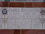 A tablet formed of five tiles of varying sizes, bordered by yellow and blue flowers in an art nouveau style