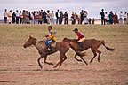 Two young riders across the finish line.