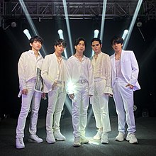 An image of SB19 posing, with each member wearing all-white outfits