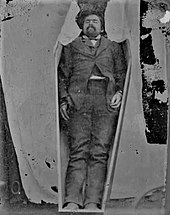 Photograph of the deceased Richards propped inside a coffin