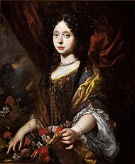 A teenage-girl sports a baroque-style dress enhanced with flowers in the up-folds.