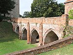 Hedingham Castle, bridge spanning dry moat between inner and outer baileys and including attached retaining wall to north west