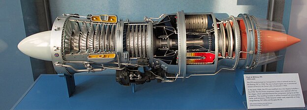 Pratt & Whitney JT3 (1/4th scale) with 12:1 pr, an example of an early jet engine with a split compressor. It also needed starting/low speed bleed overboard from between the two compressors, closed above 90% N2.[60] A bleed valve vent with blue-painted mesh guard (half removed) is visible.