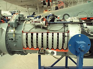 This unidentified aircraft gas turbine shows axial compressor details, the blade passages where diffusion takes place in the rotor blades and stationary stators (not visible but their orientation is evident from the appearance of the welds fixing the vanes in place). The first row of vanes are the inlet guide vanes shown with a horizontal orientation which means the air leaves the vanes in the axial direction. Immediately following are the spinning rotor blades which the air has to hit within a narrow range of low-loss angles. The apparent mismatch of directions is resolved in reality because the axial velocity and the tangential or peripheral velocity of the fast-moving blades add in their defining velocity triangle to give the required narrow incidence range relative to the blades.