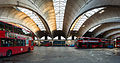 Image 15 Stockwell Garage Photograph: David Iliff An interior view of Stockwell Garage, a large bus garage in Stockwell, London, designed by Adie, Button and Partners and opened in 1952. The 393-foot-long (120 m) roof structure, seen here, is supported by ten very shallow "two-hinged" arched ribs, between which are cantilevered barrel vaults topped by large skylights. The garage, which could originally hold 200 buses, has been a Grade II* Listed Building since 1988. More selected pictures