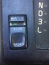 Button on Volvo 850 to select between economy and sport modes, as well as button to select winter traction mode.