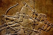 7th-century BC relief depicting Ashurbanipal (r. 669–631 BC) and three royal attendants in a chariot. From the North Palace at Nineveh