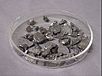 Several dozen small angular stone like shapes, grey with scattered silver flecks and highlights.