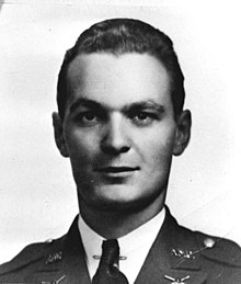 Photograph of a man's head and shoulders. The man is looking directly at the camera. He is wearing a military uniform.