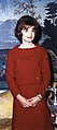 First Lady Jacqueline Kennedy wearing a red wool dress with matching jacket. She was a fashion icon in the early 1960s.
