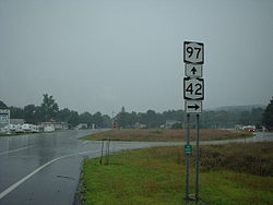 A intersection where NY 42 and NY 97 split into two different roads, located in Sparrow Bush, New York