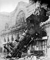 Image 2 1895 train wreck, Gare Montparnasse Photo credit: Studio Lévy and Sons On October 22, 1895, the Granville–Paris Express train overran the buffer stop at Gare Montparnasse station. The engine careened across almost 30 metres (100 feet) of the station concourse, crashed through a 60 centimetre thick wall, shot across a terrace and sailed out of the station, plummeting onto the Place de Rennes 10 metres (30 feet) below where it stood on its nose. While all of the passengers on board the train survived, one woman on the street below was killed by falling masonry. More featured pictures