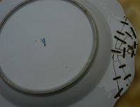 Staples used to repair a Meissen plate.
