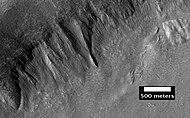 Place where a lobate debris apron begins. Note stripes which indicate movement. Image located in Ismenius Lacus quadrangle.