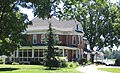 Portrait of a house along the south side of Indiana State Road 120 on the east side of Howe, Indiana.