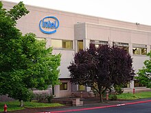 Beige stucco office at Intel Corporation's Hawthorn Farm campus. Building includes the company's logo on the exterior.