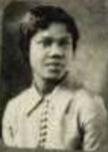 A blurry picture of a young Black woman wearing a collared blouse