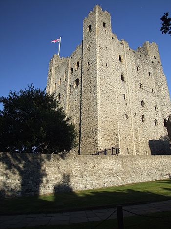 A stone tower with windows; the ones higher up are larger.