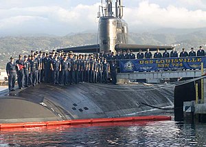 The crew of the Los Angeles class submarine USS Louisville (SSN-724) pose for a picture with their submarine.