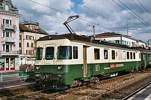 Green-and-white train at side platform