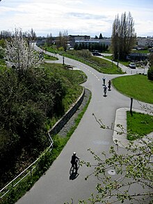 Cyclists at the Switch Bridge intersection of the Galloping Goose Regional Trail and Lochside Regional Trail in Victoria, British Columbia