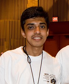 Photograph of Harsha Suryanarayana smiling and posing for a group photograph with his team at ACM-ICPC 2006 World Finals