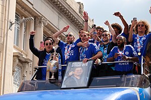 Leicester City players celebrate on an open-top bus