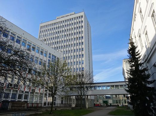 The tower at Nr.1, an extension at Nr.3 (left), the pedestrian bridge, and the historical building (right)