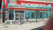 Photo of a small, glass panelled light rail station entrance