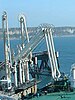A marine loading arm connects an oil tanker to a pier.