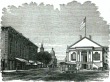 Black and white engraving of a grand Greek revival civic building before an open space paved with dirt and granite