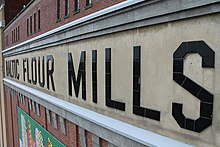 Side-view of the BALTIC FLOUR MILLS lettering. The preservation of the original lettering signifies the building's relationship to its history.