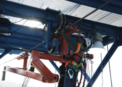 A worker inspects the hauling frame at the launch gantry.