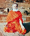 Rāmabhadrācārya meditating on the banks of Mandakini river during a Payovrata. He is seated in the Sukhasana pose with fingers folded in the Chin Mudra.