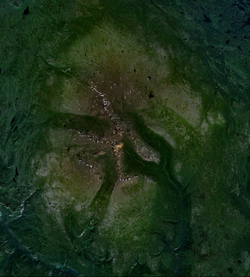 A massive open volcano situated on a plateau consisting of a series of buttes and ridges.