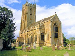 Yellow stone building with square tower.