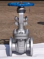 A 2″ stainless steel gate valve with flanged ends. Bolts connect the lower valve body with the upper “bonnet”. Visible threads on the valve stem protruding above the handwheel show that this is a rising-stem valve.