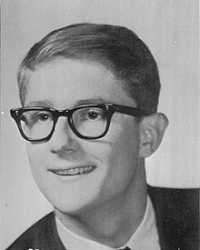 Photo of William Woods's face in 1967. He has glasses, short slicked-back hair, and no facial hair; he is wearing a suit.