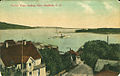 Red Head Point and the peninsula of Beinn Bhreagh can be seen across the bay from the town of Baddeck, Nova Scotia in a 1906 postcard.