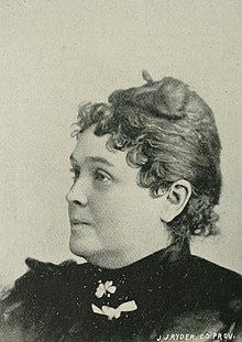 B&W portrait photo of a woman with dark hair in an up-do