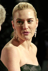 A profile view of Winslet as she speaks into a microphone.