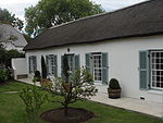 Free-standing L-shaped single storey cottage regarded as one of the finest and least-altered in old Wynberg; building well set back from street; full hipped thatch roof; possibly original sash windows (24 panes) and double leafed panelled door with glazi Type of site: House Current use: House.