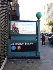 Staircase entrance to the 75th Avenue station, descending below street level. This entrance is located on the north side of Queens Boulevard.