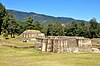 Two stone temple platforms in a grassy area